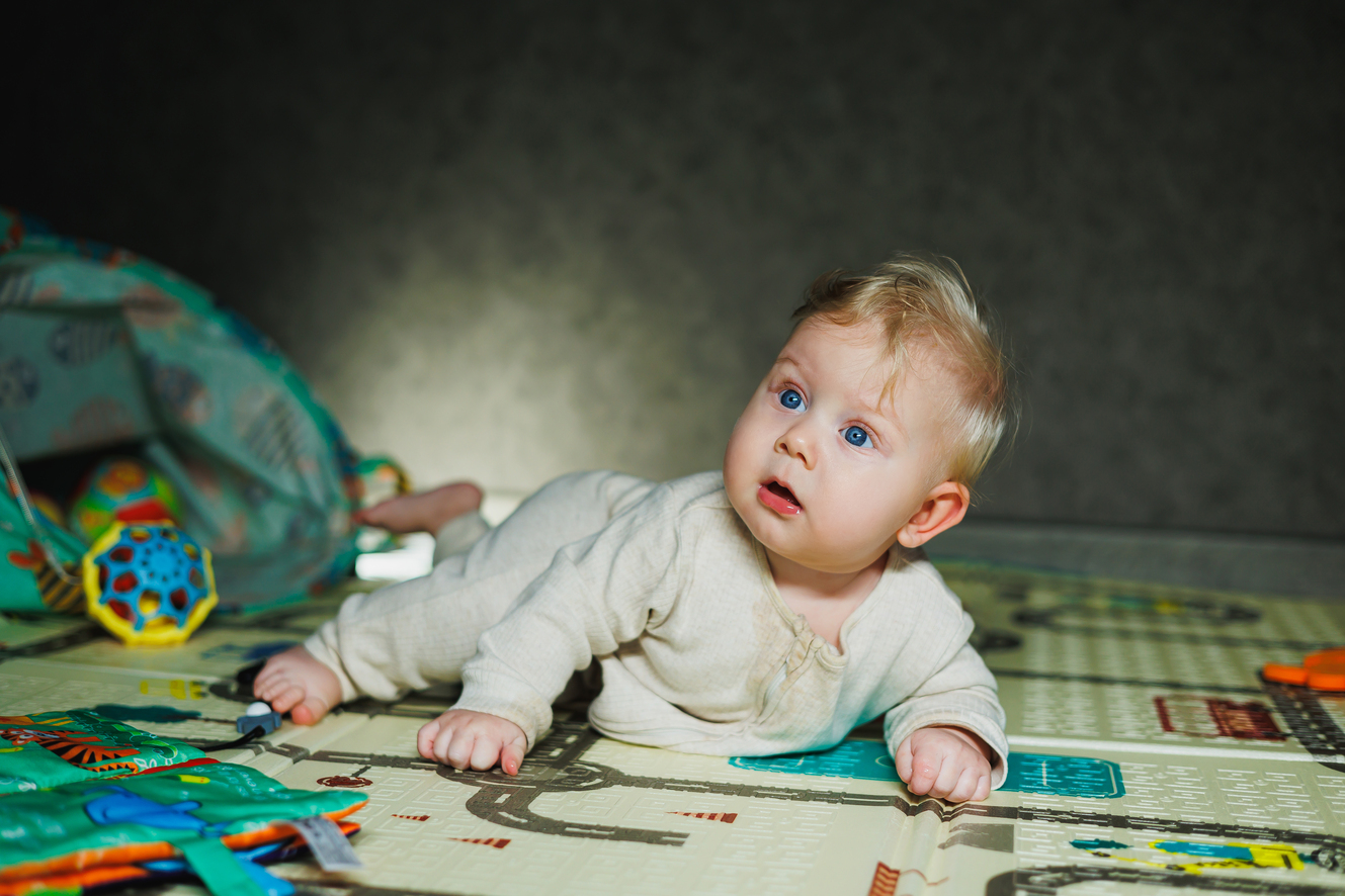 Baby awake in a dimly lit nursery at night