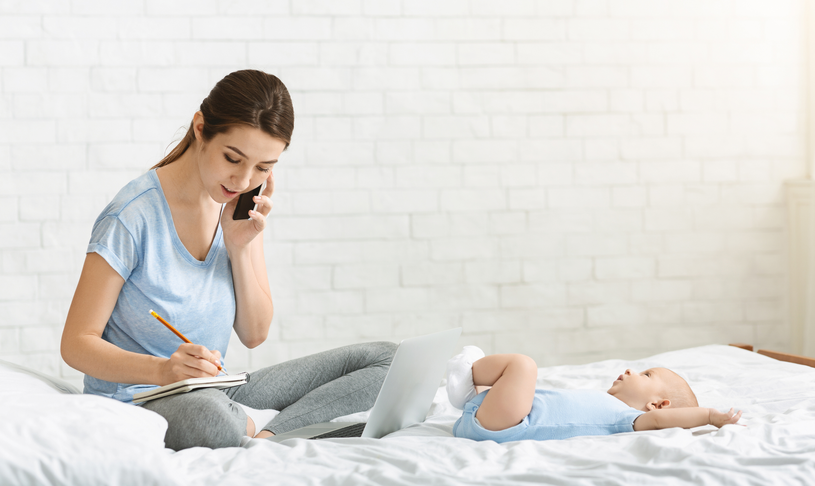 Parent noting baby sleep patterns in a quiet room