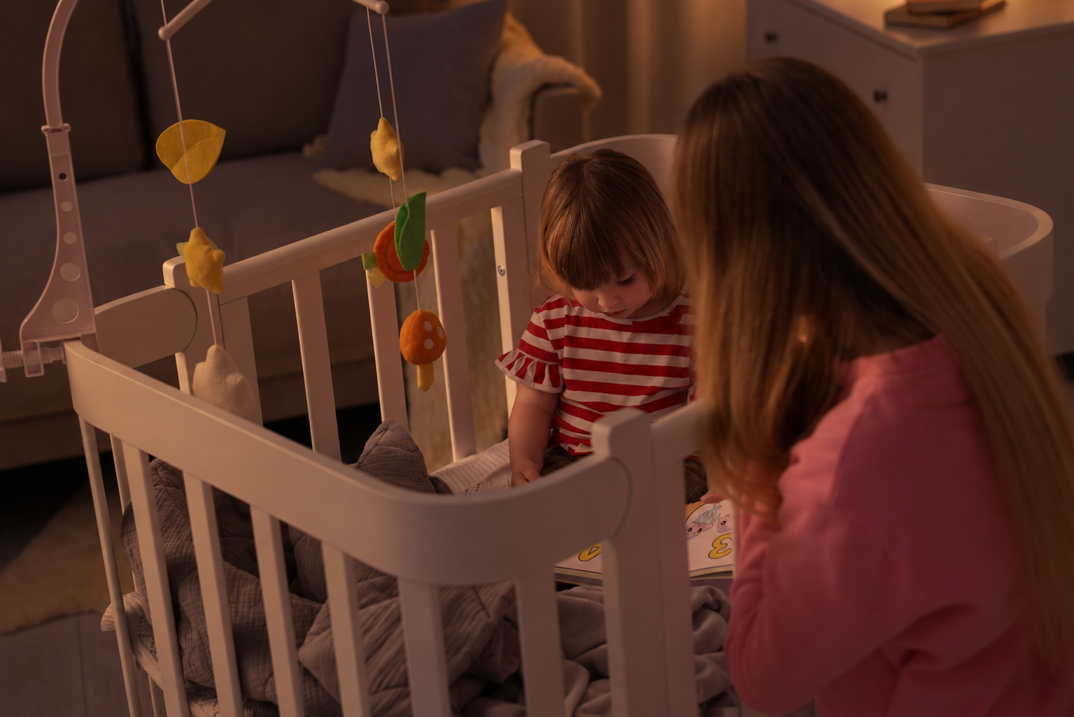 Calm bedtime scene with parent reading to a toddler