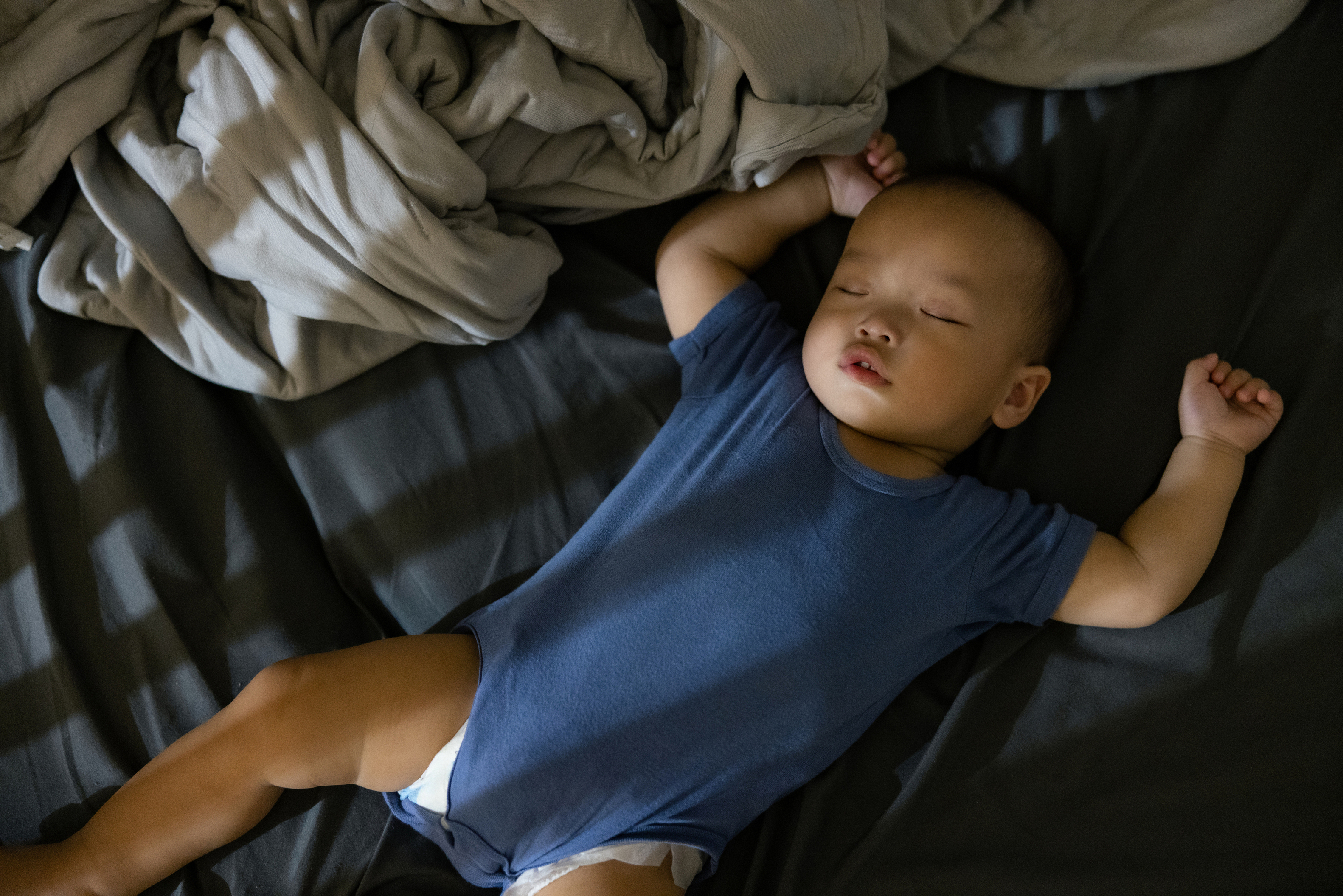 Baby sleeping safely on their back in a crib