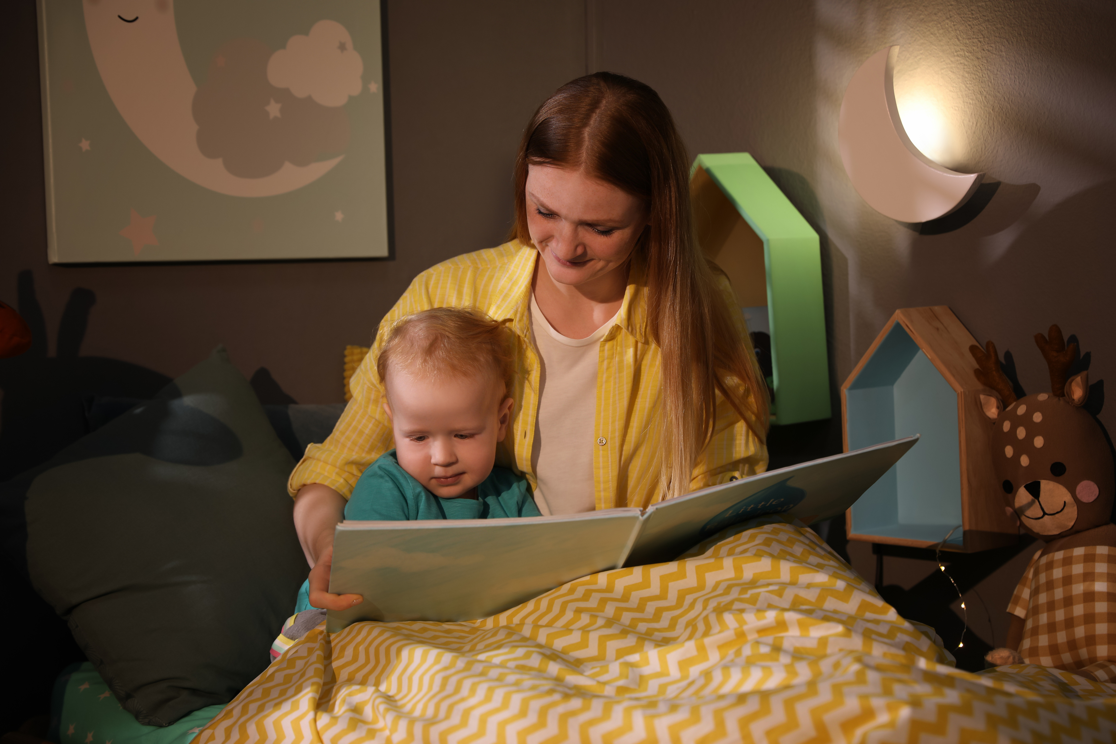Caregiver reading with toddler before bedtime