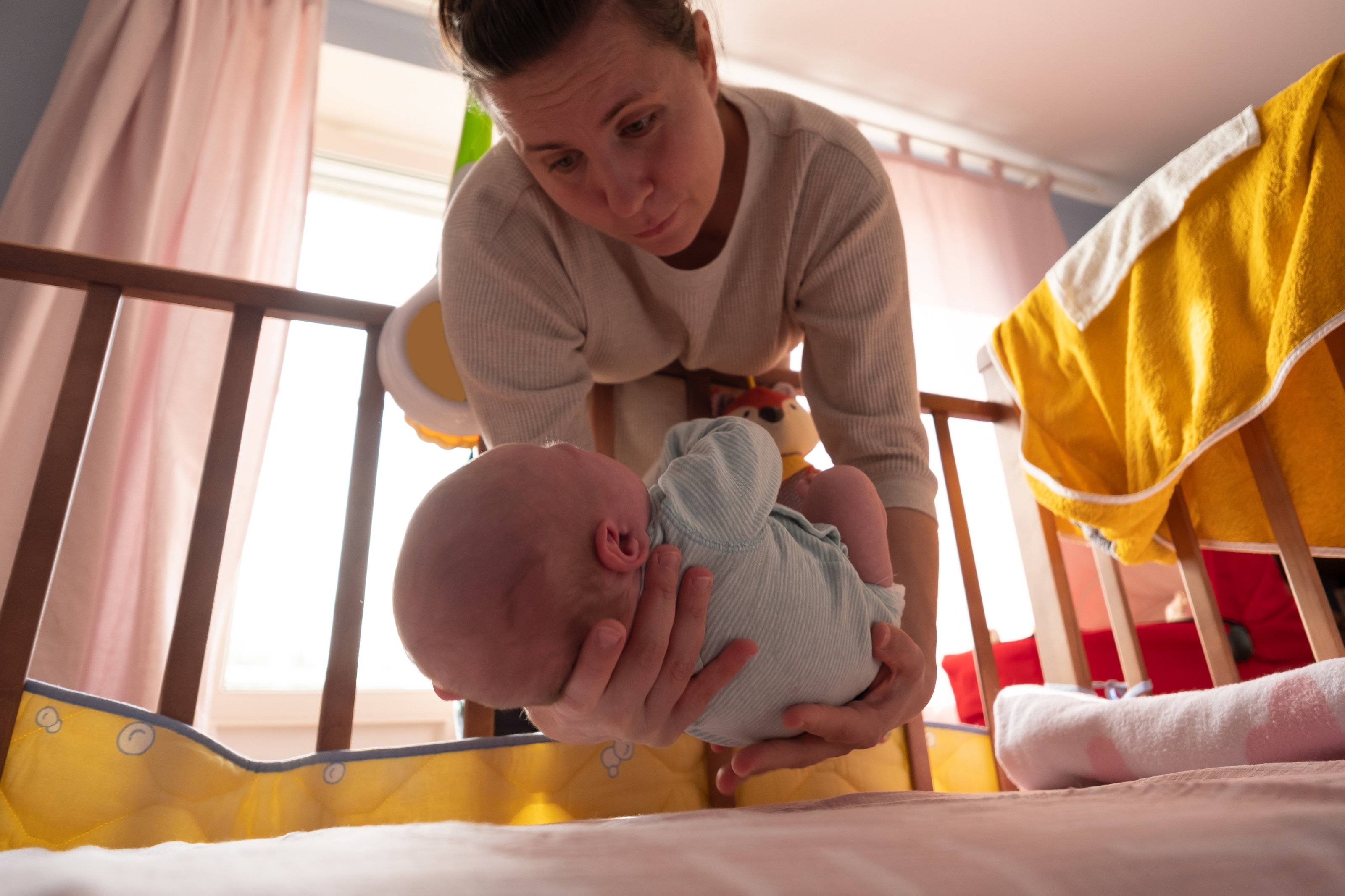 Calm bedtime routine beside an uncluttered crib